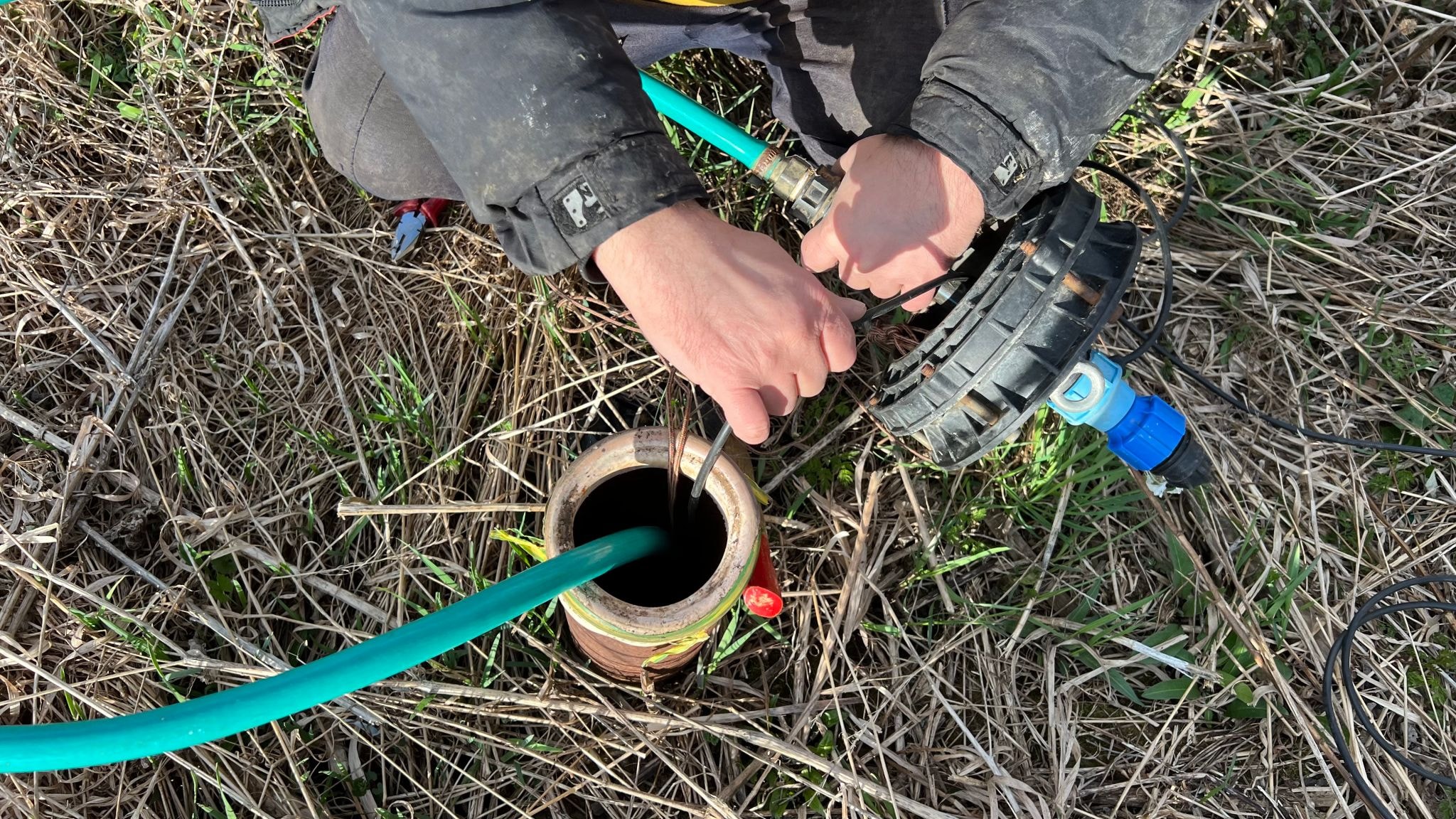 Technician purging a groundwater monitoring well in the field