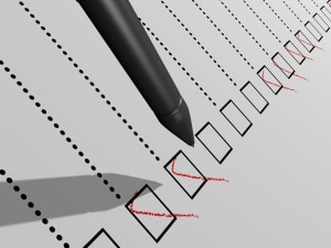Pen checking boxes on a compliance checklist